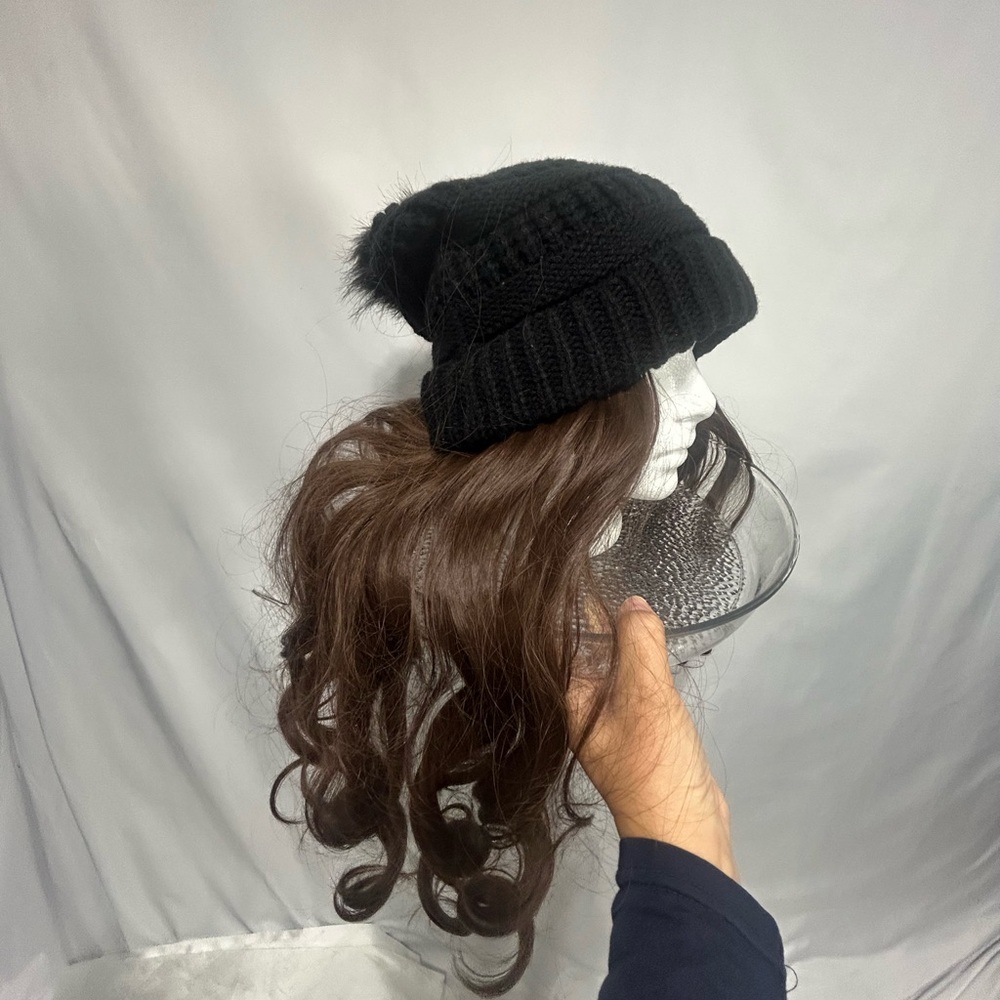 Elegant Black Knit Beanie with Faux Fur Pom and removable hair extensions.